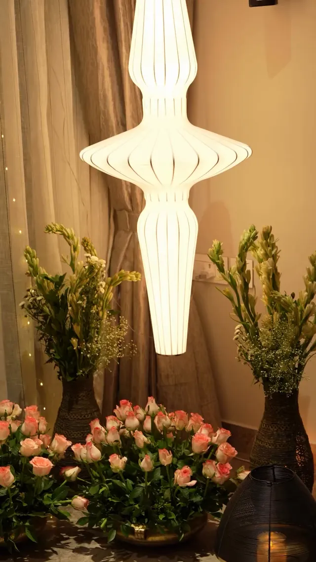 White lantern above blush roses and greenery
